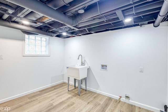 clothes washing area featuring hookup for a washing machine, hookup for a gas dryer, and hardwood / wood-style floors