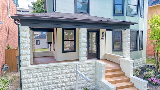 view of exterior entry with covered porch