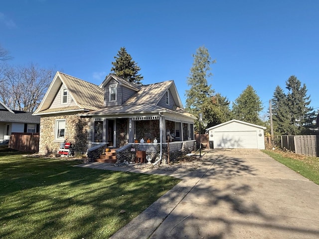 view of front of home with a porch, a garage, an outdoor structure, and a front yard