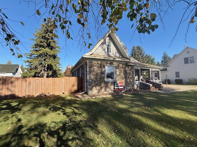 rear view of property with a yard