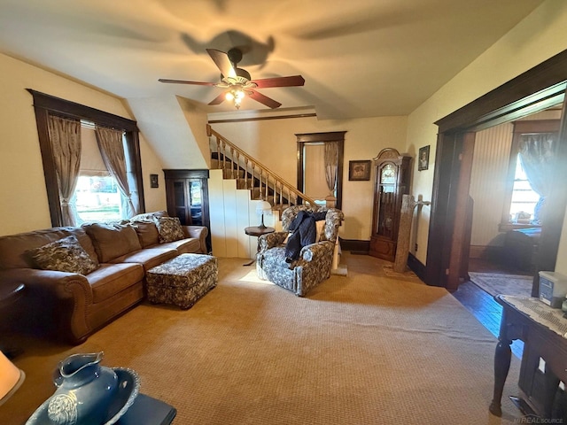 carpeted living room featuring ceiling fan