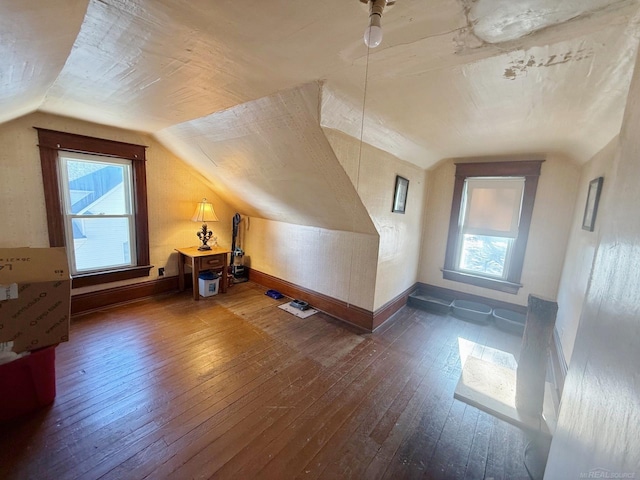 additional living space featuring plenty of natural light, hardwood / wood-style floors, and lofted ceiling