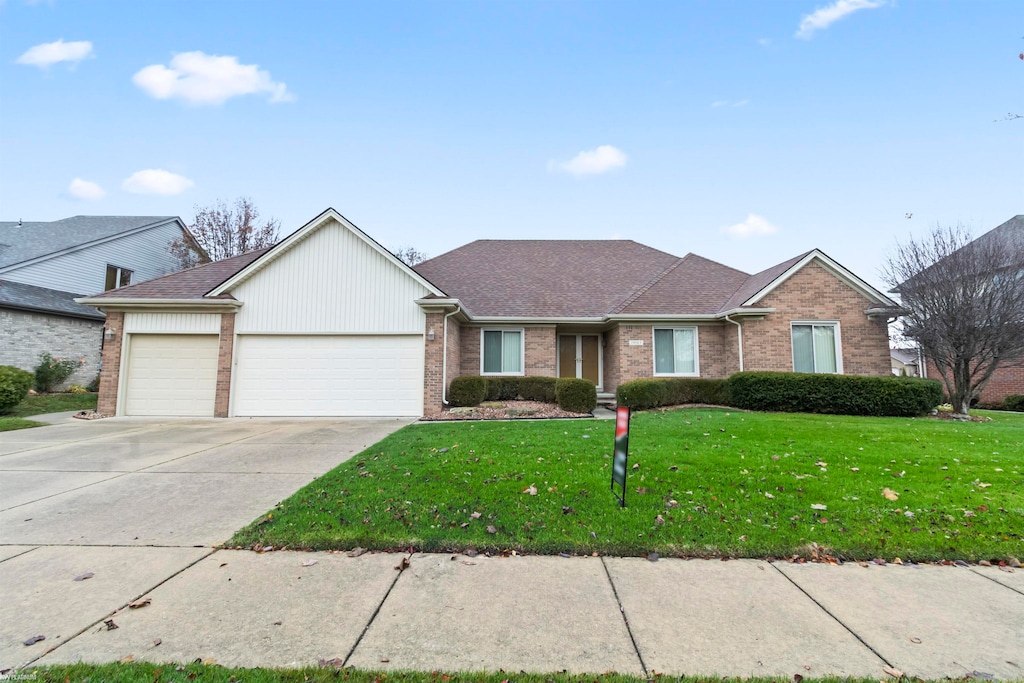 single story home with a garage and a front yard