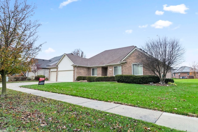 view of front of house with a front yard and a garage