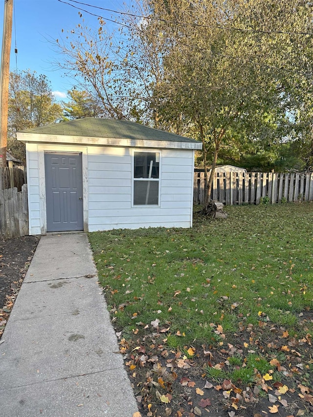 view of outbuilding featuring a yard