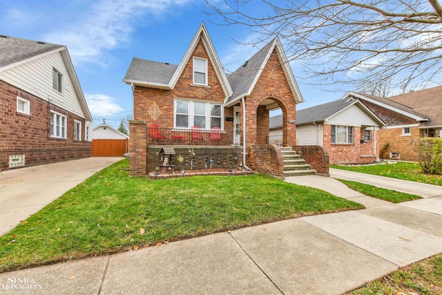 tudor home featuring a front yard