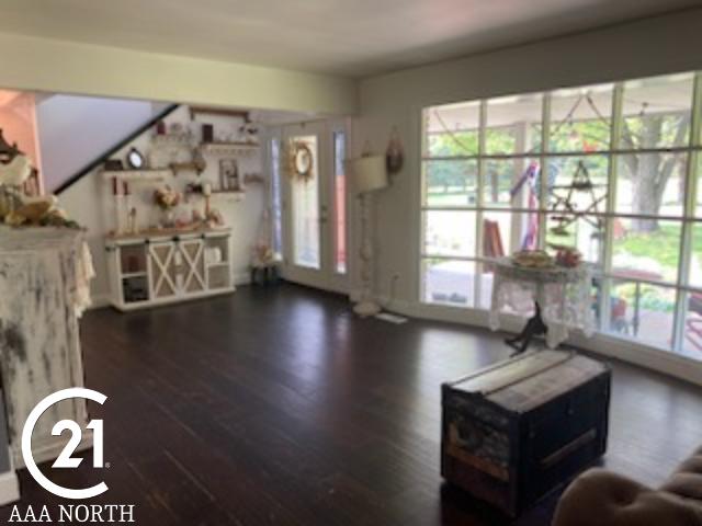 unfurnished living room featuring dark hardwood / wood-style flooring