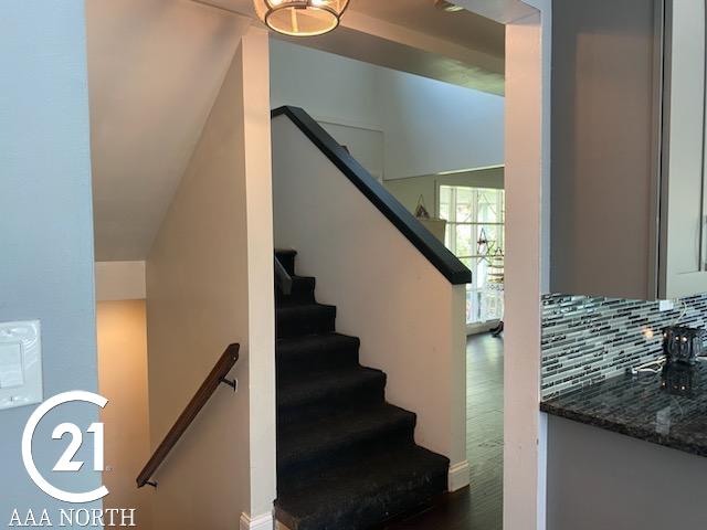 stairway with hardwood / wood-style flooring