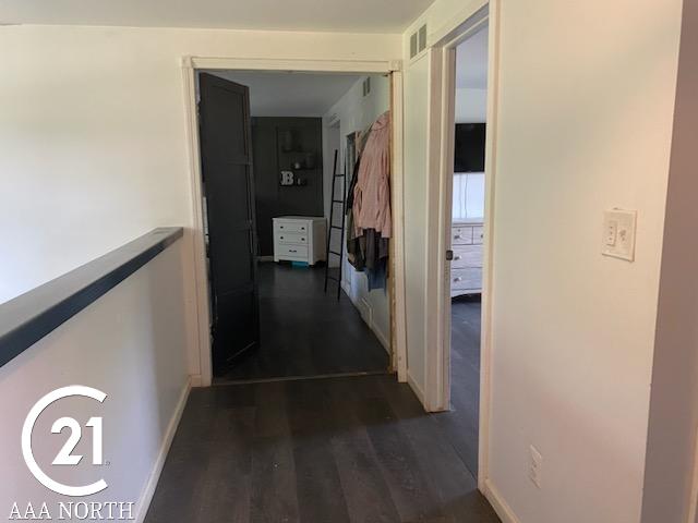 corridor featuring dark hardwood / wood-style flooring