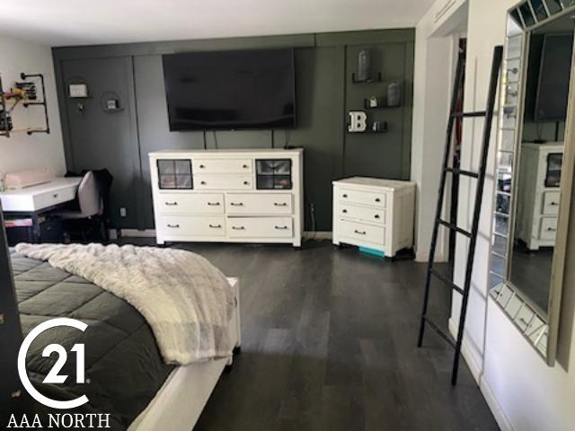 bedroom with dark wood-type flooring