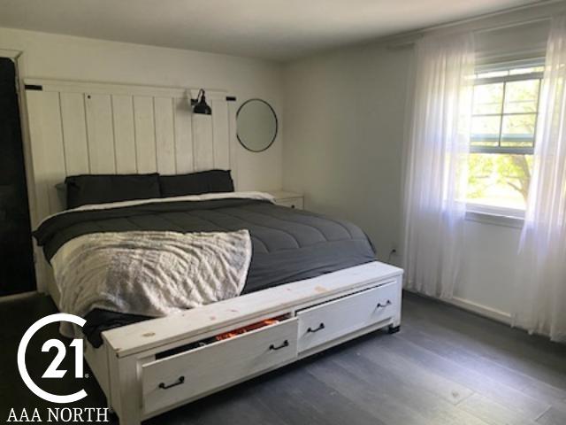 bedroom with dark hardwood / wood-style flooring