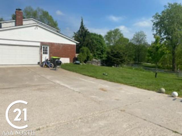 view of home's exterior with a lawn and a garage