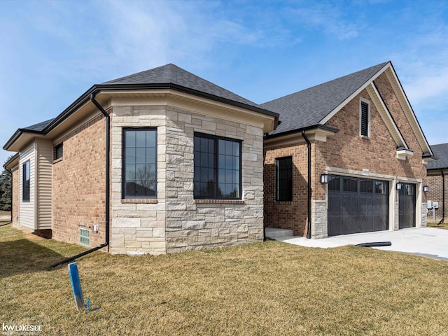 view of property exterior featuring brick siding, roof with shingles, a lawn, stone siding, and driveway