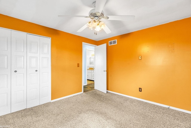 unfurnished bedroom with ceiling fan, carpet floors, and a closet