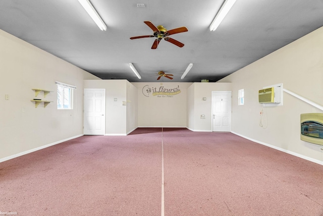 interior space featuring an AC wall unit, heating unit, and carpet