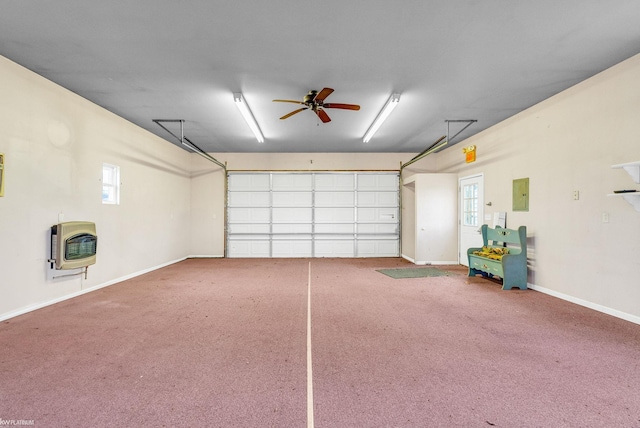 garage with heating unit, ceiling fan, and electric panel