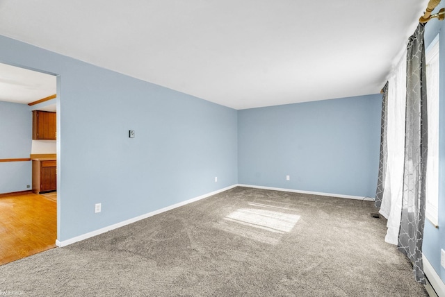 empty room with light hardwood / wood-style flooring and plenty of natural light