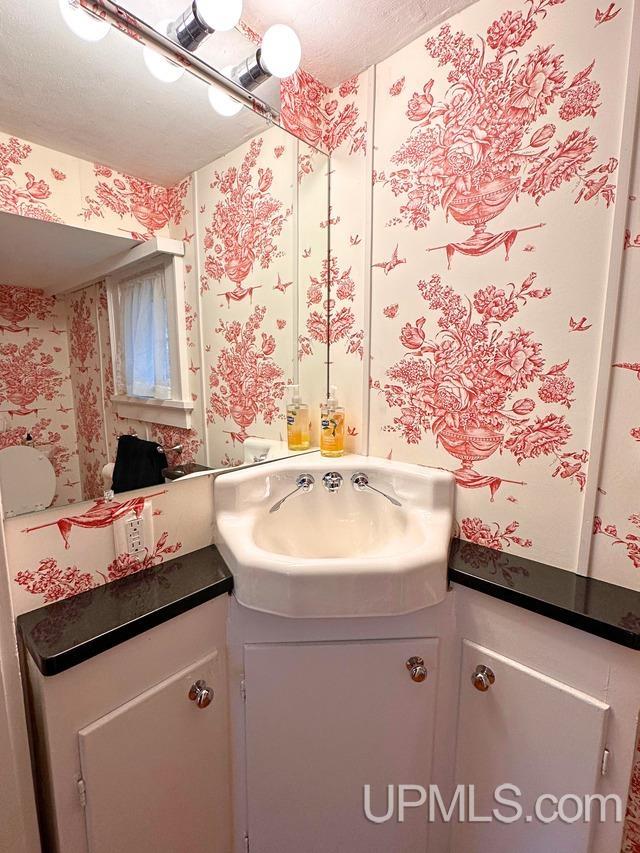 bathroom with vanity and a textured ceiling