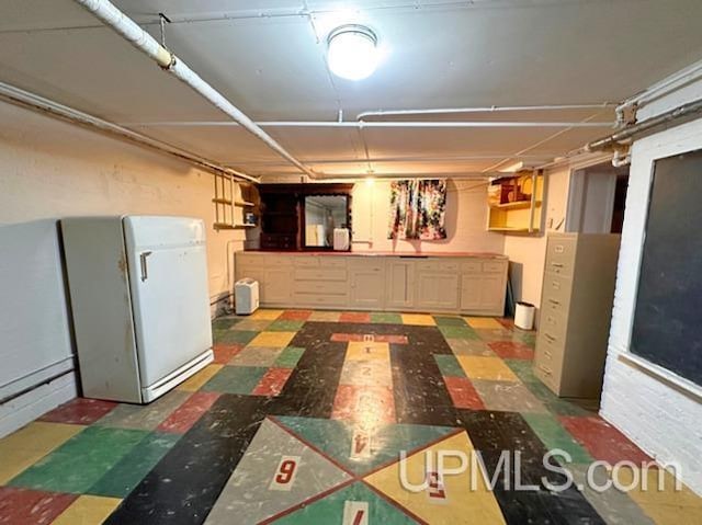 basement with white refrigerator