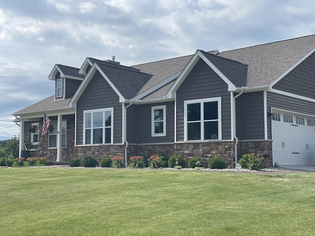 craftsman-style home featuring a garage and a front lawn