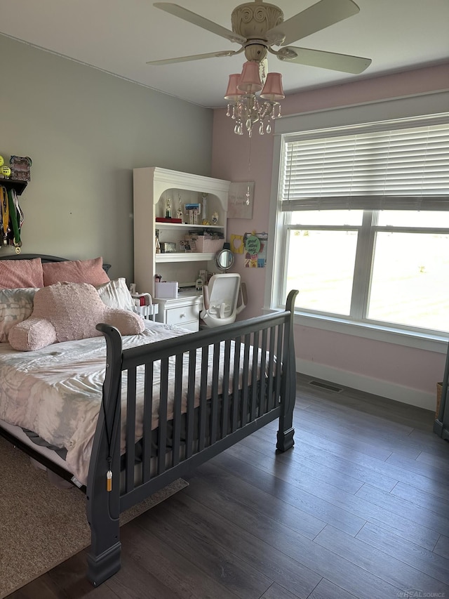 bedroom with ceiling fan and dark hardwood / wood-style floors