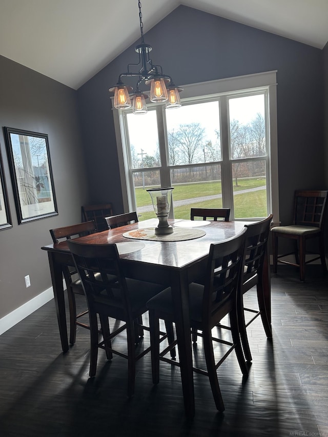 dining area with lofted ceiling and dark hardwood / wood-style floors