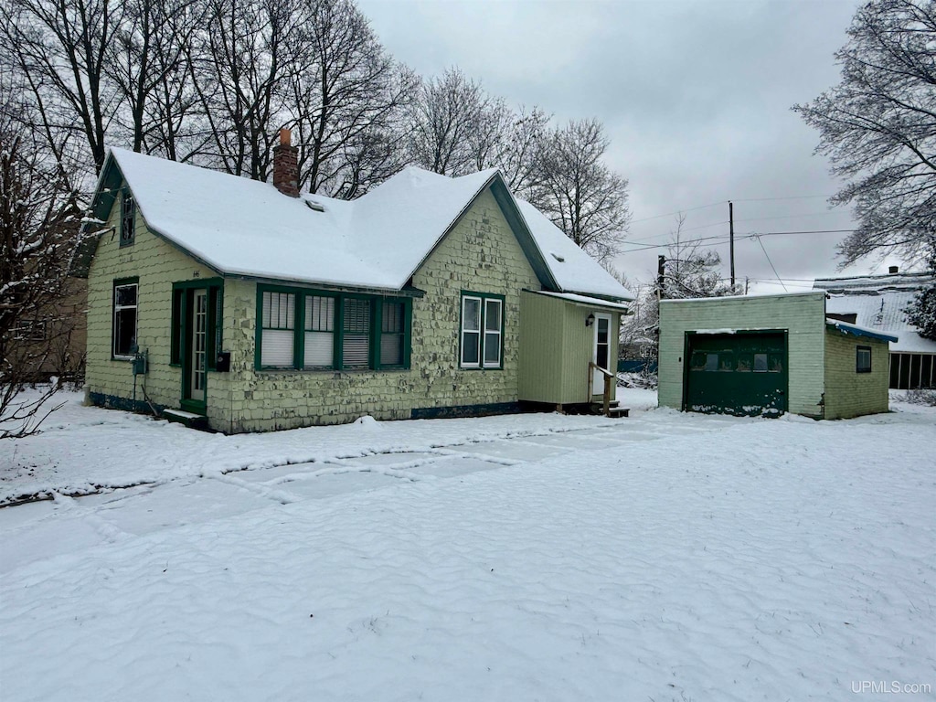 exterior space featuring a garage and an outdoor structure