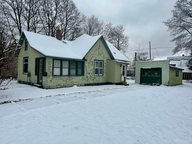 exterior space featuring a garage and an outdoor structure