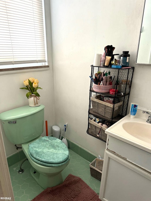 bathroom with tile patterned flooring, vanity, and toilet