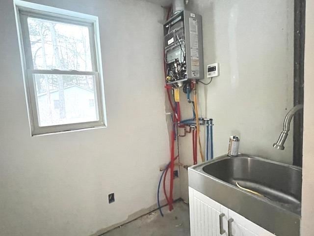 utility room featuring sink and water heater