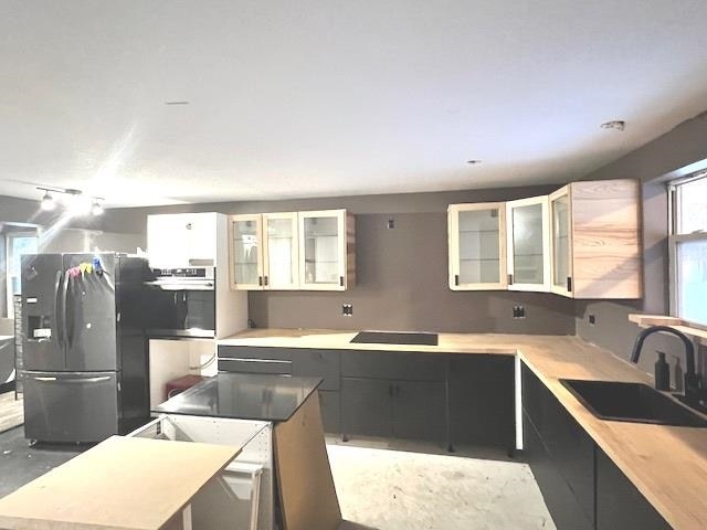 kitchen with sink, white cabinets, and appliances with stainless steel finishes