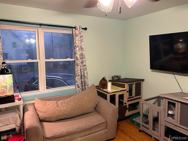 sitting room featuring ceiling fan and wood finished floors