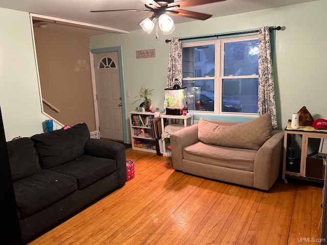 living room with ceiling fan and light wood-type flooring