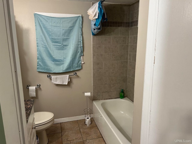 full bathroom featuring tile patterned floors, vanity, toilet, and tiled shower / bath