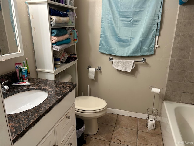 full bathroom featuring a bathtub, toilet, vanity, baseboards, and tile patterned floors