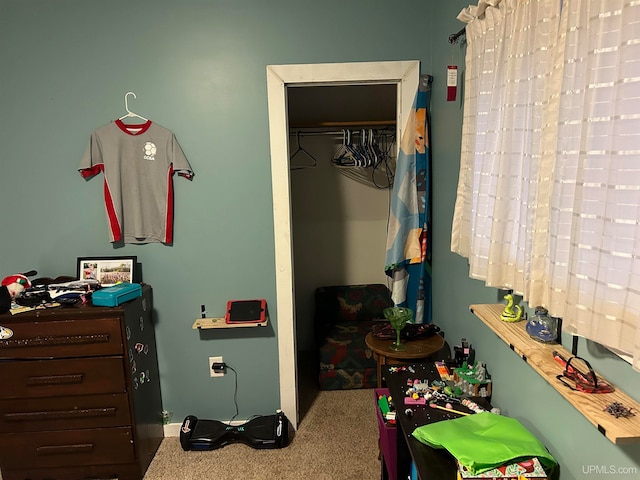 bedroom with carpet and a closet