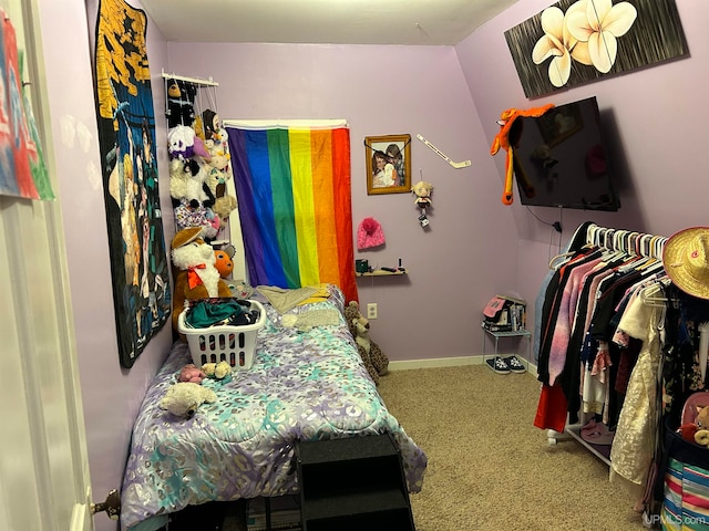 bedroom with lofted ceiling and carpet floors