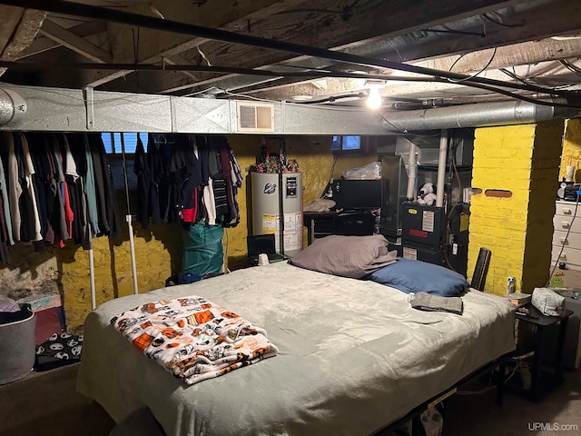 bedroom featuring water heater and visible vents