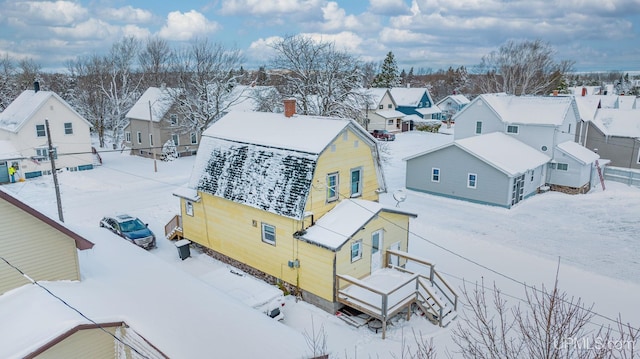 snowy aerial view featuring a residential view