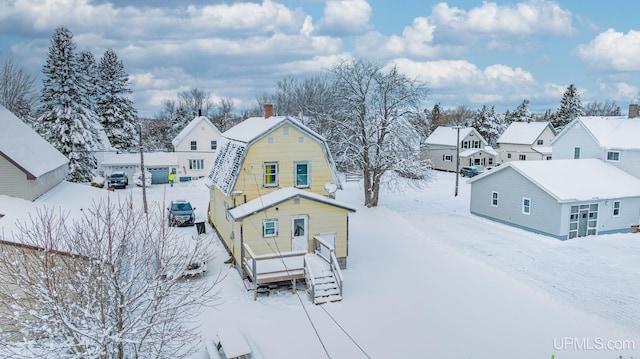 snowy aerial view featuring a residential view