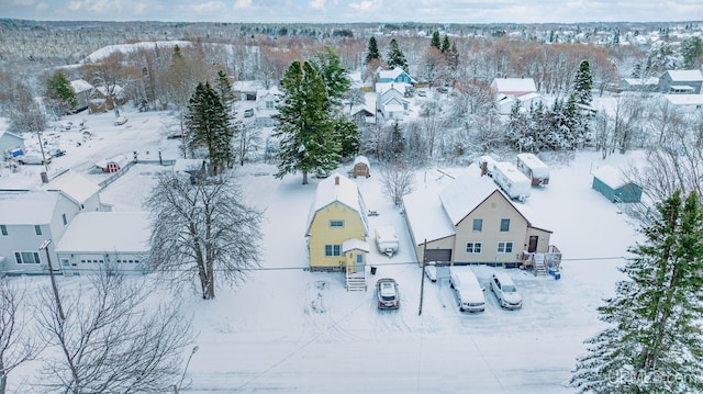 snowy aerial view with a residential view