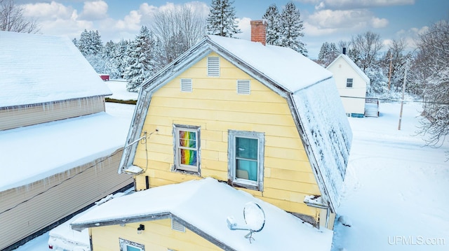 snow covered house with a chimney