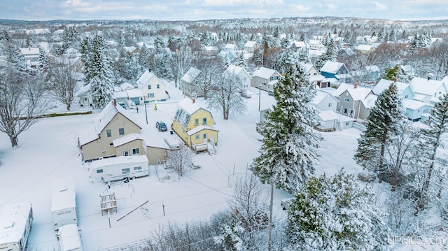 snowy aerial view featuring a residential view