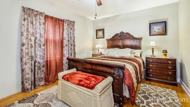 bedroom with ceiling fan and light hardwood / wood-style flooring