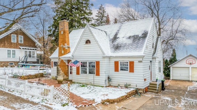 view of front of house featuring a garage, an outbuilding, and a trampoline