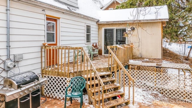 snow covered deck featuring grilling area