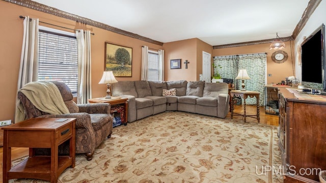 living room with light hardwood / wood-style flooring and crown molding