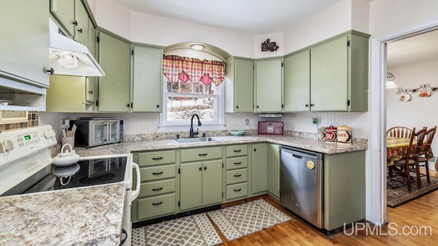 kitchen with dishwasher, range, light hardwood / wood-style floors, and green cabinets