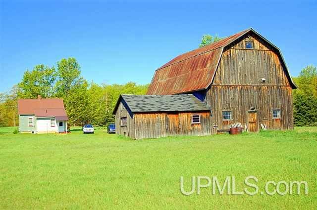 view of outbuilding featuring a lawn