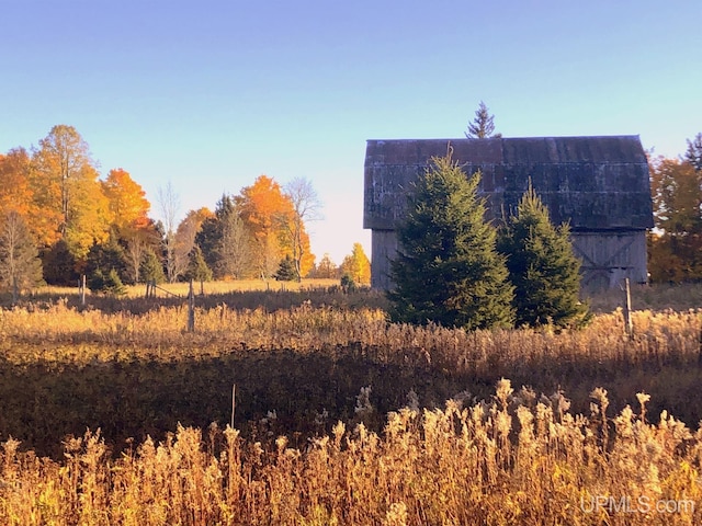 view of property exterior with a rural view